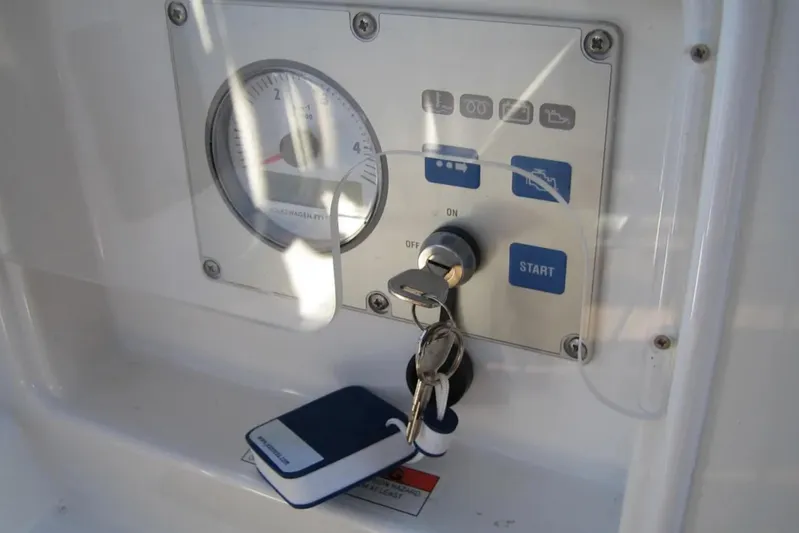 Tenacity Yacht Photos Pics Control panel with keys for a 2011 Jeanneau 57 yacht, featuring start button and gauge.