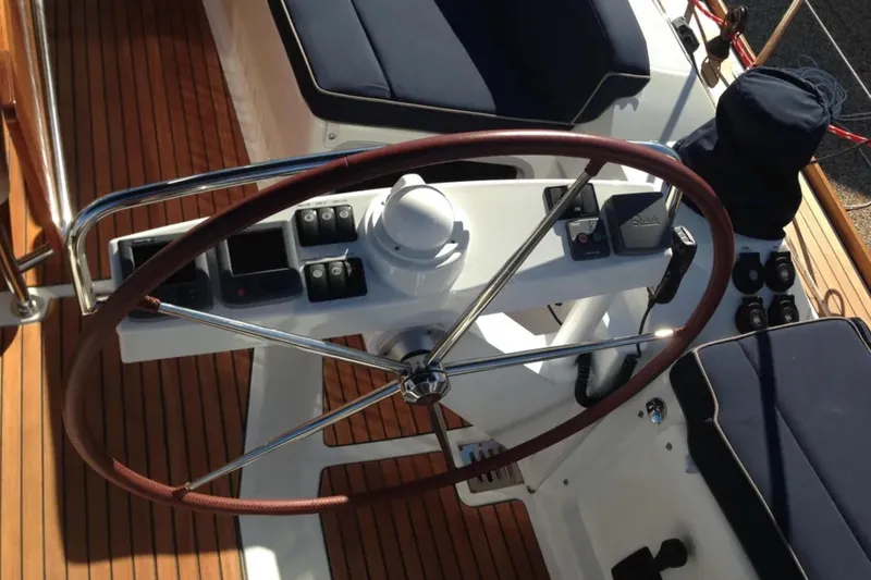 Tenacity Yacht Photos Pics Steering wheel and controls of 2011 Jeanneau 57 yacht on teak deck.