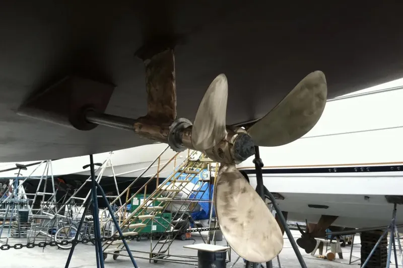 Tenacity Yacht Photos Pics Propeller of 2011 Jeanneau 57 yacht in dry dock, showing maintenance setup.