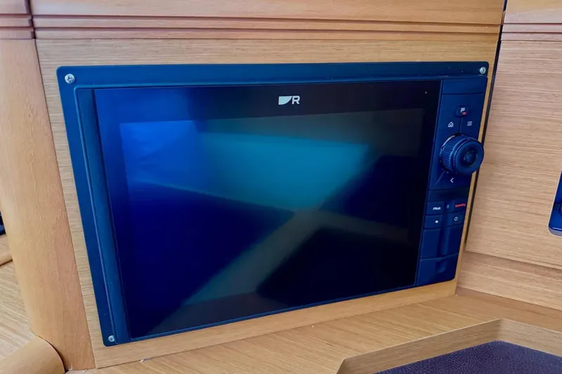 Tenacity Yacht Photos Pics Navigation display on a 2011 Jeanneau 57 yacht, featuring a sleek control panel.