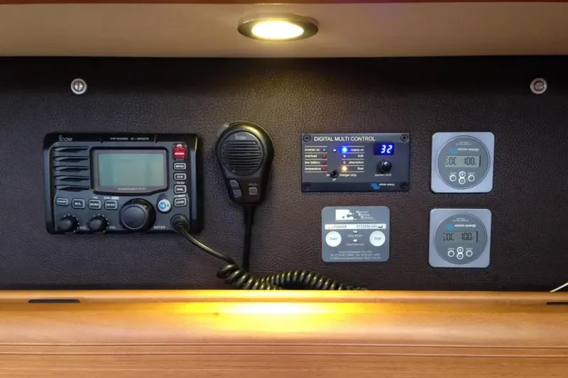 Tenacity Yacht Photos Pics Control panel of a 2011 Jeanneau 57 yacht with radio and digital displays.