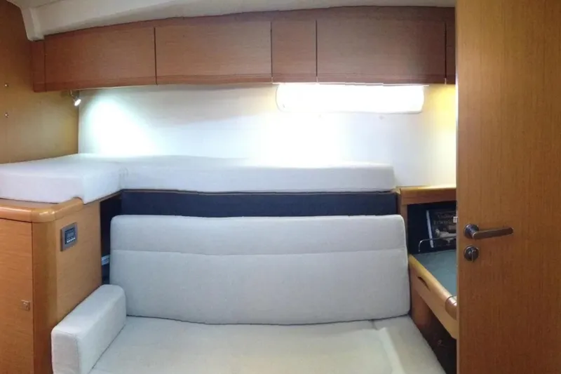 Tenacity Yacht Photos Pics Interior cabin of 2011 Jeanneau 57 yacht with cozy seating and storage.