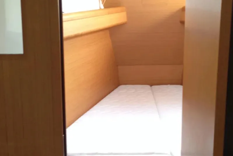 Tenacity Yacht Photos Pics Interior cabin of 2011 Jeanneau 57 yacht with wooden finish and mattress.