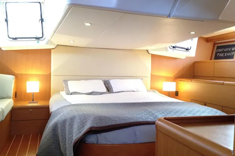 Tenacity Yacht Photos Pics Luxurious cabin interior of 2011 Jeanneau 57 yacht with cozy bed and ambient lighting.