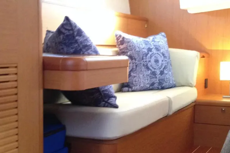 Tenacity Yacht Photos Pics Interior of 2011 Jeanneau 57 yacht with cozy seating and decorative pillows.