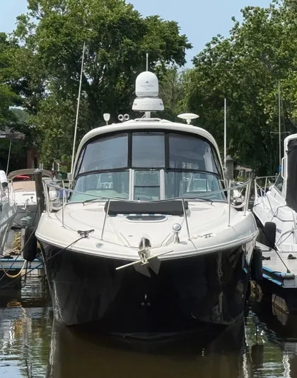  Yacht Photos Pics 2011 Sea Ray 350 Sundancer yacht docked, surrounded by trees and other boats.