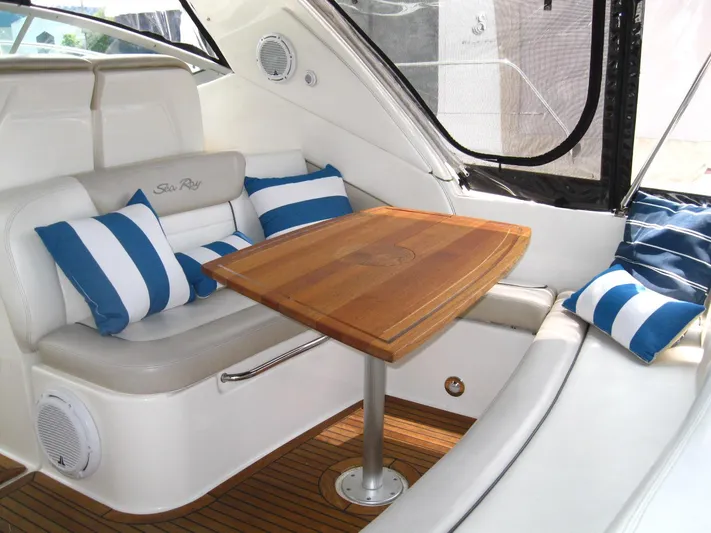  Yacht Photos Pics Luxurious interior of 2011 Sea Ray 350 Sundancer with striped cushions and wooden table.