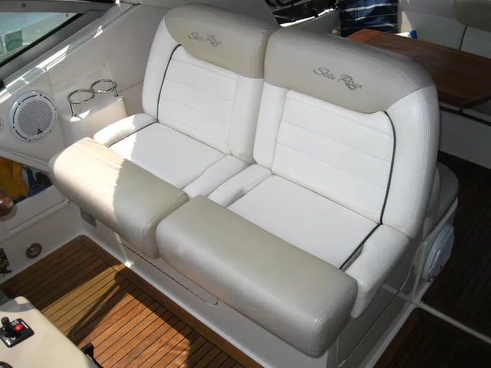  Yacht Photos Pics Luxurious seating on 2011 Sea Ray 350 Sundancer boat with white upholstery and wood flooring.
