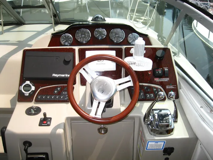  Yacht Photos Pics Cockpit of 2011 Sea Ray 350 Sundancer with steering wheel and navigation controls.