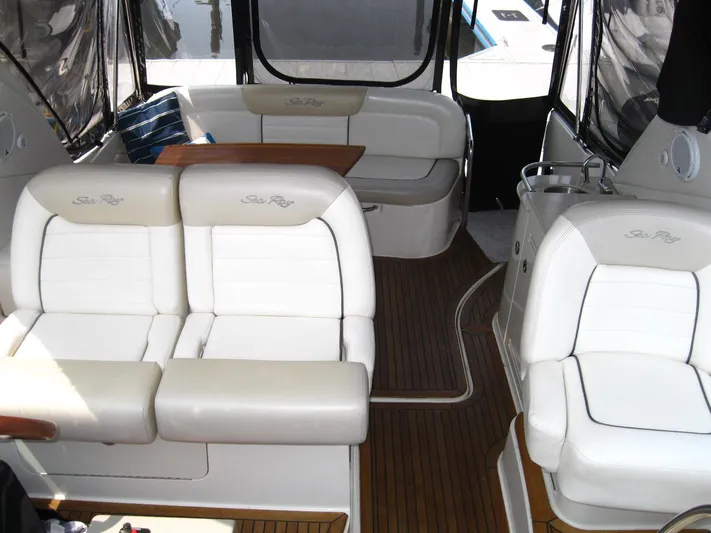  Yacht Photos Pics Interior of 2011 Sea Ray 350 Sundancer with white seating and wooden flooring.