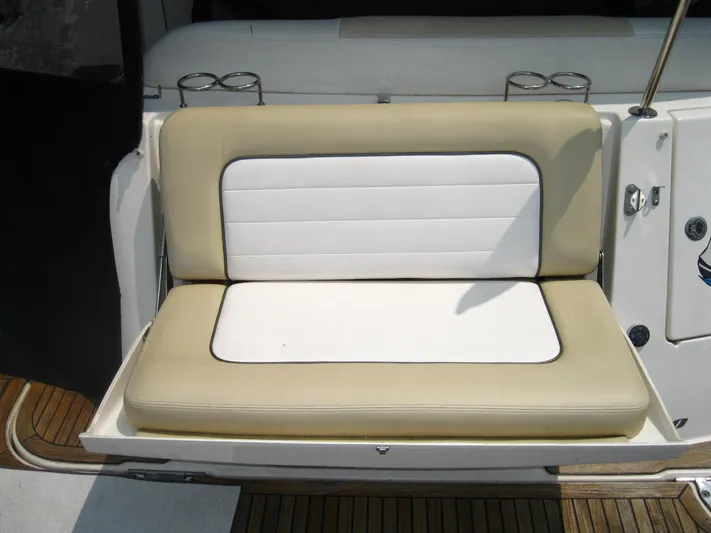  Yacht Photos Pics 2011 Sea Ray 350 Sundancer boat seat with beige and white cushions, cup holders, and teak flooring.