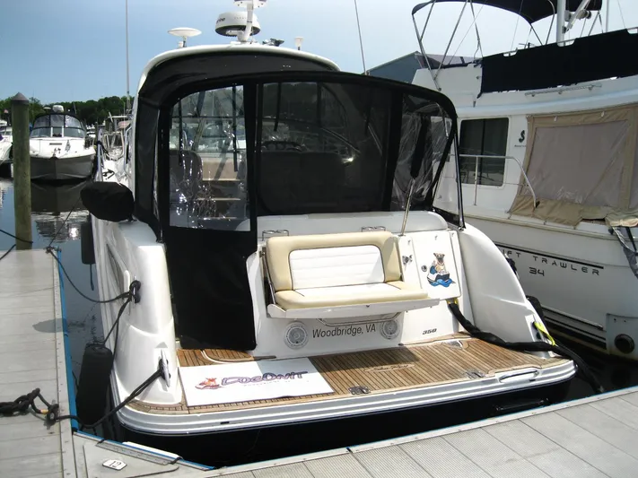  Yacht Photos Pics 2011 Sea Ray 350 Sundancer docked, featuring a spacious rear deck and seating area.