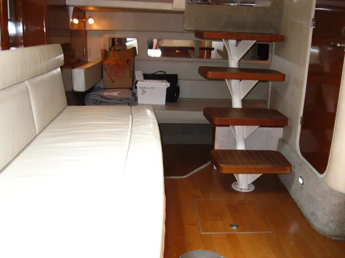  Yacht Photos Pics Interior of 2011 Sea Ray 350 Sundancer yacht with wooden steps and white seating.