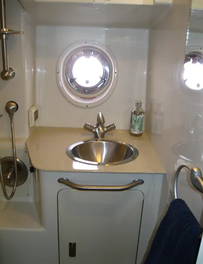  Yacht Photos Pics 2011 Sea Ray 350 Sundancer bathroom with sink, porthole, and showerhead.