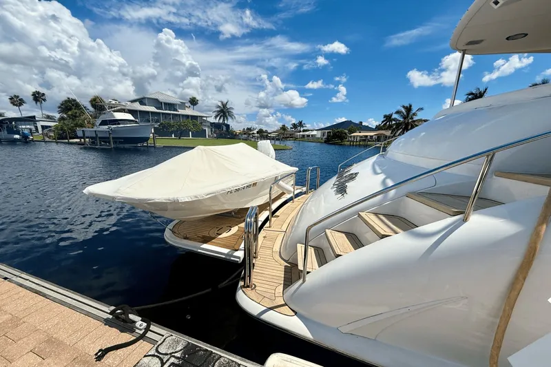 Marsha Sea Yacht Photos Pics 2005 Lazzara 68 Flybridge yacht docked by a scenic waterfront.