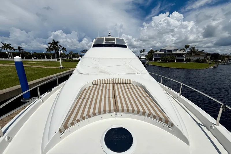 Marsha Sea Yacht Photos Pics 2005 Lazzara 68 Flybridge yacht with striped sunbathing area, docked by palm trees.