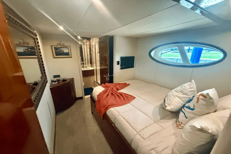 Marsha Sea Yacht Photos Pics Luxurious cabin interior of 2005 Lazzara 68 Flybridge yacht with cozy bed and porthole window.