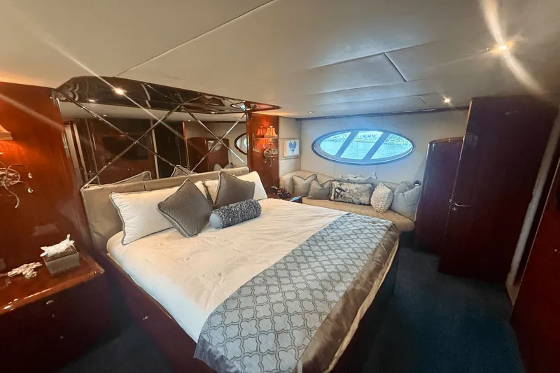 Marsha Sea Yacht Photos Pics Luxurious bedroom interior of 2005 Lazzara 68 Flybridge yacht with elegant decor and large window.
