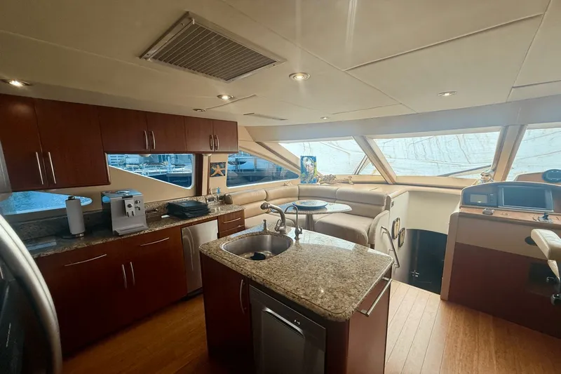 Marsha Sea Yacht Photos Pics Luxurious interior of 2005 Lazzara 68 Flybridge yacht with modern kitchen and seating area.