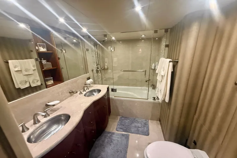 Marsha Sea Yacht Photos Pics Luxurious bathroom in 2005 Lazzara 68 Flybridge yacht with dual sinks and glass-enclosed shower.
