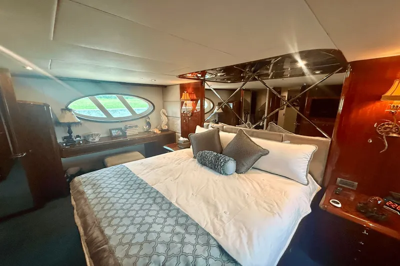 Marsha Sea Yacht Photos Pics Luxurious bedroom interior of 2005 Lazzara 68 Flybridge yacht with elegant decor and large windows.