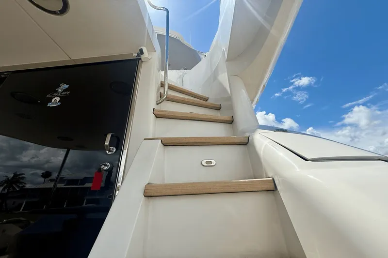 Marsha Sea Yacht Photos Pics Staircase on 2005 Lazzara 68 Flybridge yacht under a clear blue sky.