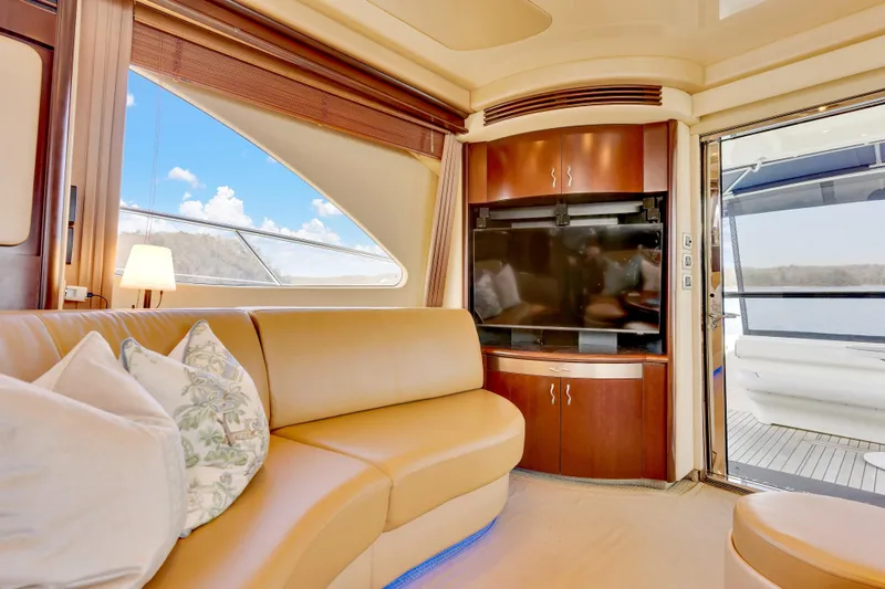  Yacht Photos Pics Luxurious interior of 2006 Sea Ray 58 Sedan Bridge yacht with leather seating and large TV.