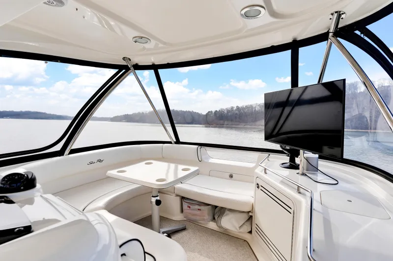  Yacht Photos Pics Interior of 2006 Sea Ray 58 Sedan Bridge yacht with seating and TV, overlooking serene water.
