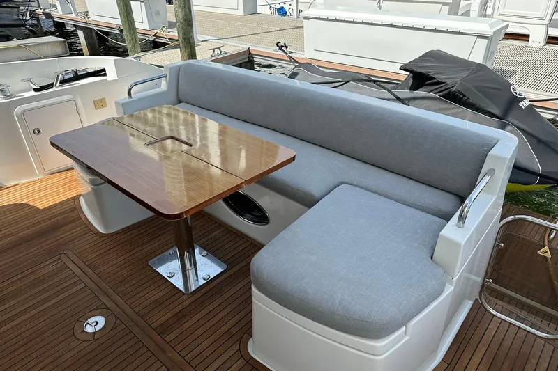  Yacht Photos Pics Luxury seating area on 2013 Azimut Fly 53 yacht with wooden table and cushioned bench.