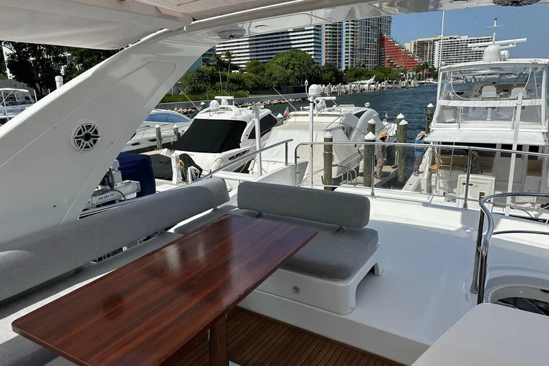  Yacht Photos Pics Luxurious 2013 Azimut Fly 53 yacht docked, featuring elegant outdoor seating and scenic marina view.