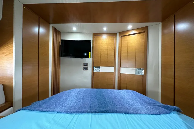  Yacht Photos Pics Luxurious bedroom interior of 2013 Azimut Fly 53 yacht with modern wood paneling.