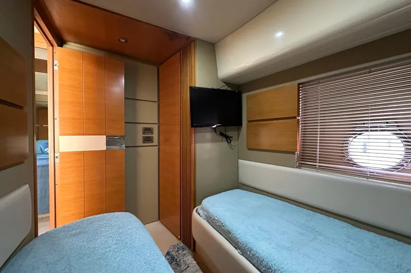  Yacht Photos Pics Interior of 2013 Azimut Fly 53 yacht cabin with twin beds and porthole window.