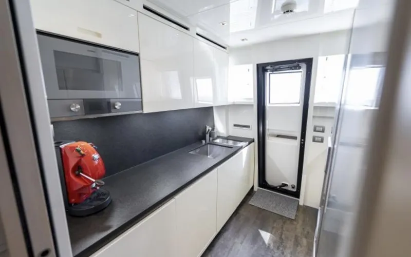 Yacht Photos Pics Modern kitchen interior on 2018 Sanlorenzo SL86 yacht, featuring sleek cabinetry and appliances.