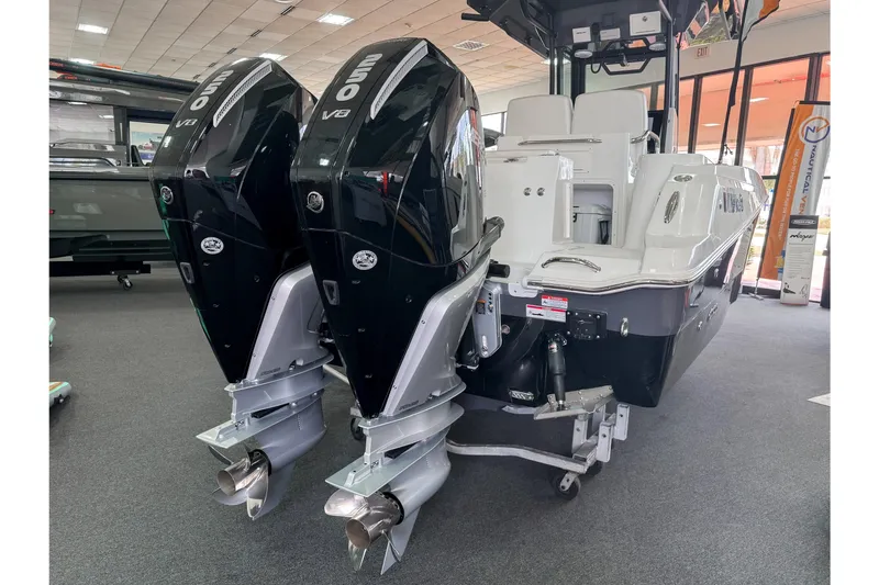  Yacht Photos Pics 2024 Wellcraft 263 Fisherman boat with dual outboard engines displayed indoors.