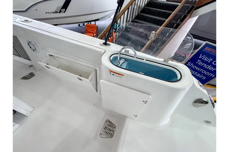  Yacht Photos Pics 2024 Wellcraft 263 Fisherman boat interior with storage and sink area.