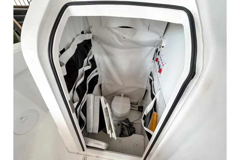  Yacht Photos Pics 2024 Wellcraft 263 Fisherman boat interior with compact marine toilet.