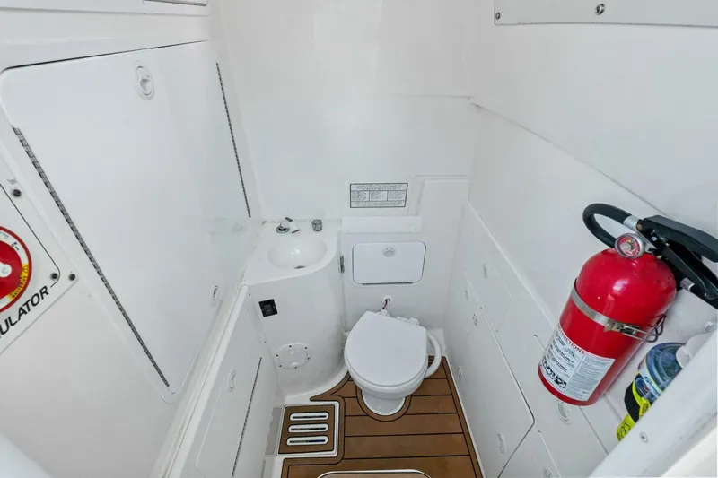  Yacht Photos Pics 2012 Regulator 32 FS boat bathroom with toilet, sink, and fire extinguisher.