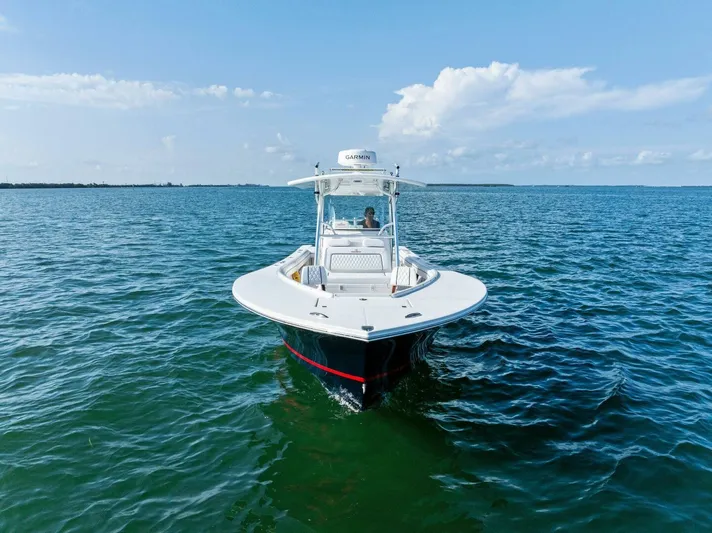  Yacht Photos Pics 2012 Regulator 32 FS boat cruising on open water under a clear blue sky.