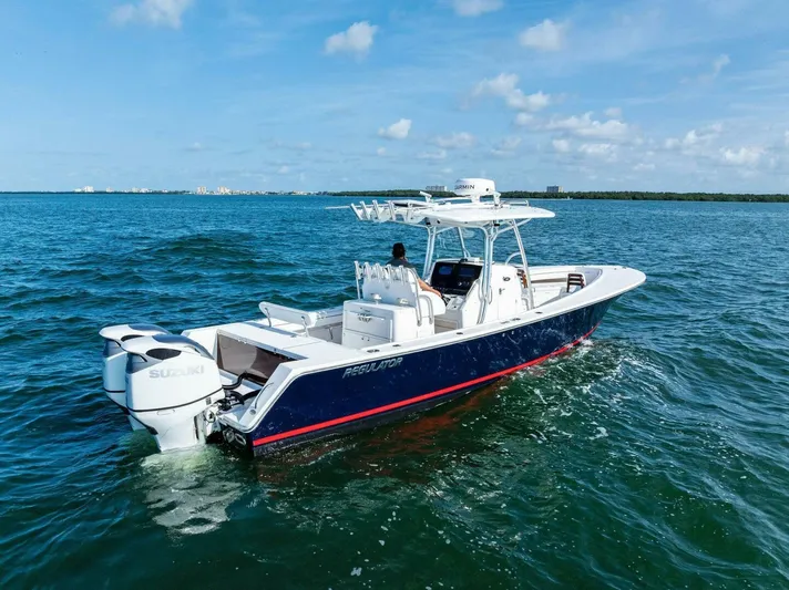  Yacht Photos Pics 2012 Regulator 32 FS boat cruising on open water under a clear blue sky.