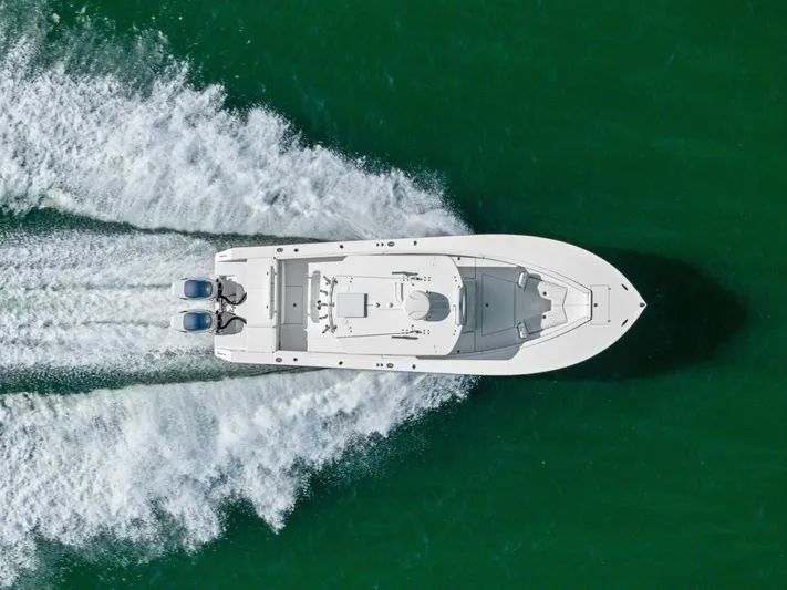  Yacht Photos Pics Aerial view of 2012 Regulator 32 FS boat speeding on green water.