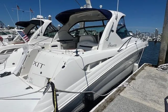 Irish Exit Yacht Photos Pics 2007 Sea Ray 38 Sundancer yacht docked at marina under clear blue sky.