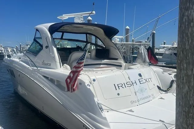 Irish Exit Yacht Photos Pics 2007 Sea Ray 38 Sundancer yacht docked, featuring "Irish Exit" name and American flag.