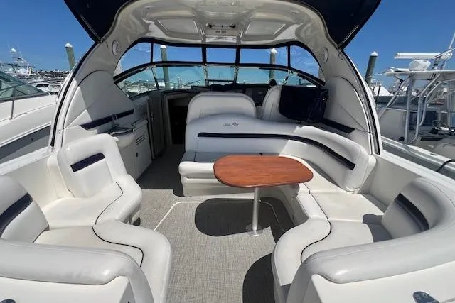 Irish Exit Yacht Photos Pics 2007 Sea Ray 38 Sundancer yacht interior with white seating and wooden table.