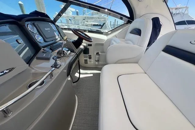 Irish Exit Yacht Photos Pics 2007 Sea Ray 38 Sundancer helm with luxurious seating and modern dashboard controls.