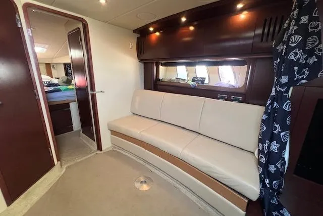 Irish Exit Yacht Photos Pics Interior of 2007 Sea Ray 38 Sundancer yacht with cream sofa and wooden accents.