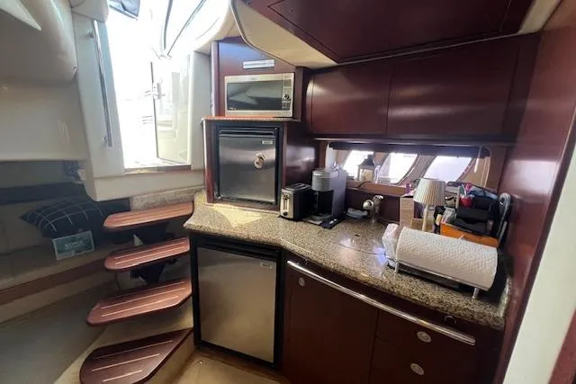 Irish Exit Yacht Photos Pics Interior of 2007 Sea Ray 38 Sundancer yacht with kitchenette and stairs.
