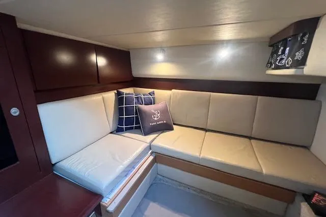 Irish Exit Yacht Photos Pics Interior of 2007 Sea Ray 38 Sundancer yacht with beige seating and decorative pillows.