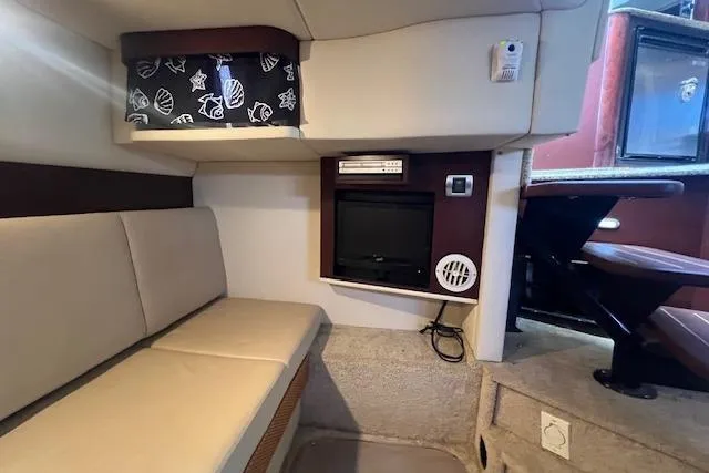 Irish Exit Yacht Photos Pics Interior of 2007 Sea Ray 38 Sundancer with seating, TV, and storage.