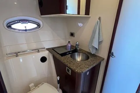 Irish Exit Yacht Photos Pics 2007 Sea Ray 38 Sundancer bathroom with granite countertop and stainless steel sink.