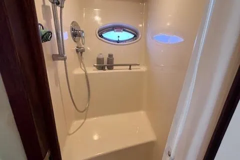 Irish Exit Yacht Photos Pics 2007 Sea Ray 38 Sundancer shower with porthole window and modern fixtures.